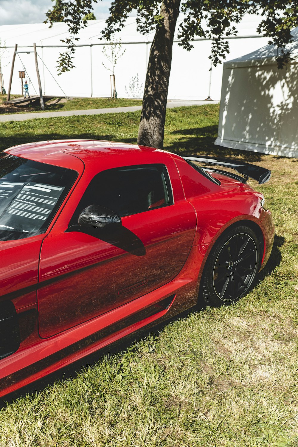 a red sports car parked in the grass