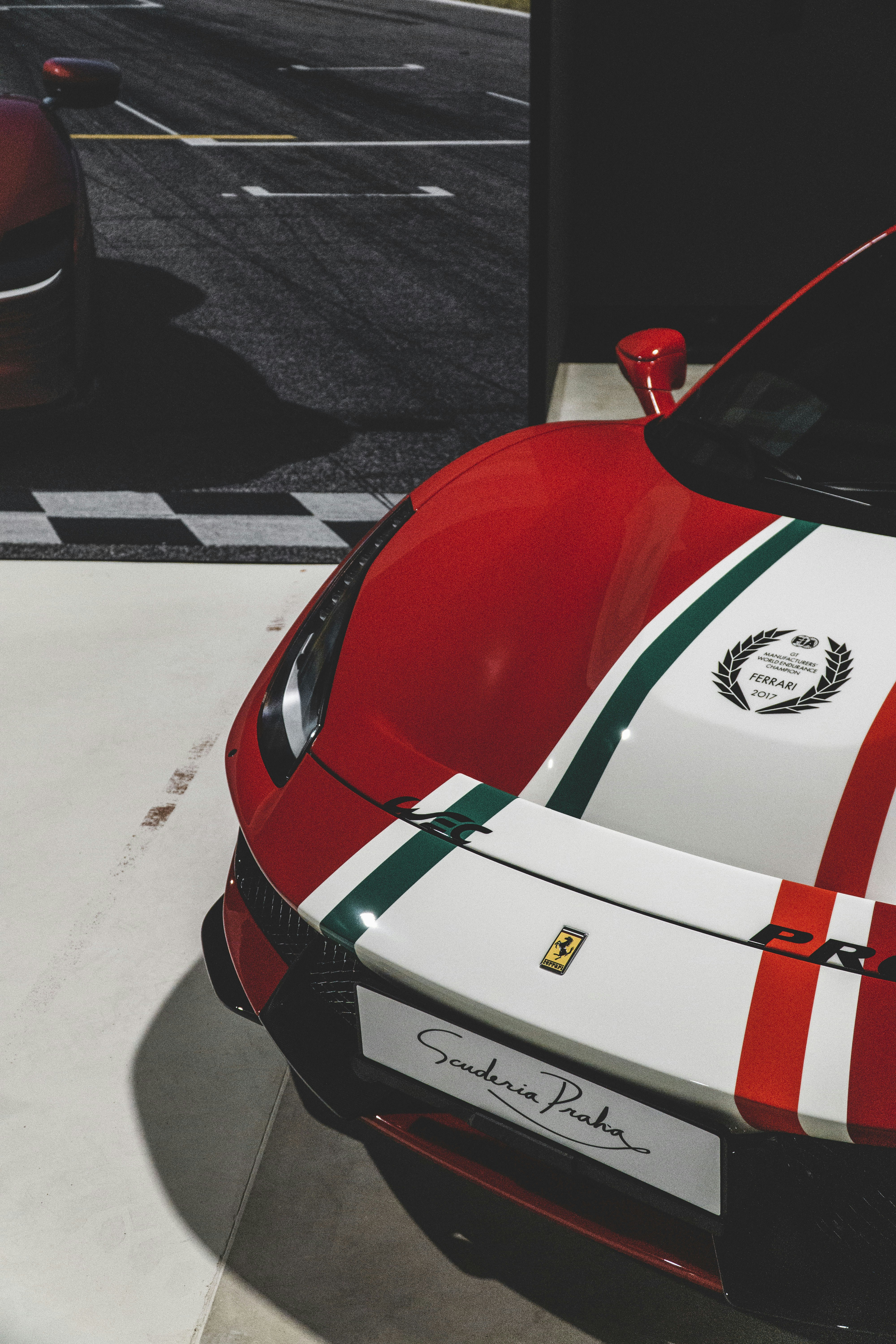 a red and white sports car parked in a parking lot