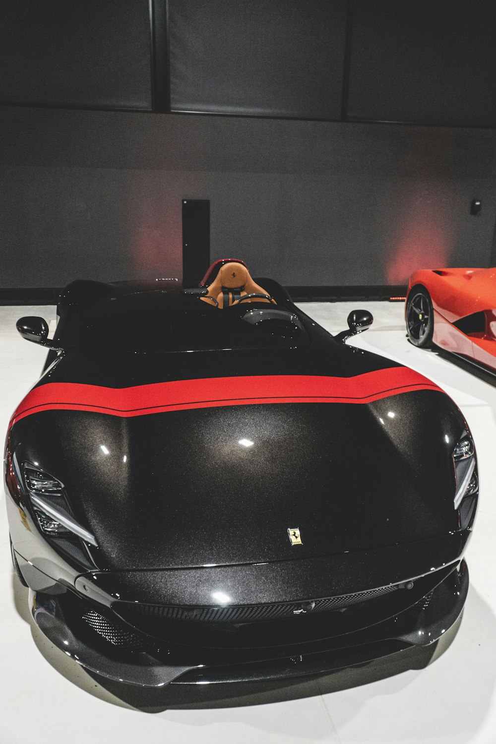 a black and red sports car is on display