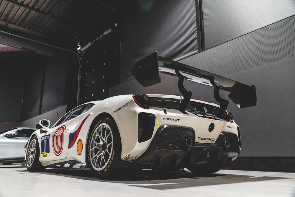 a white sports car parked in a garage