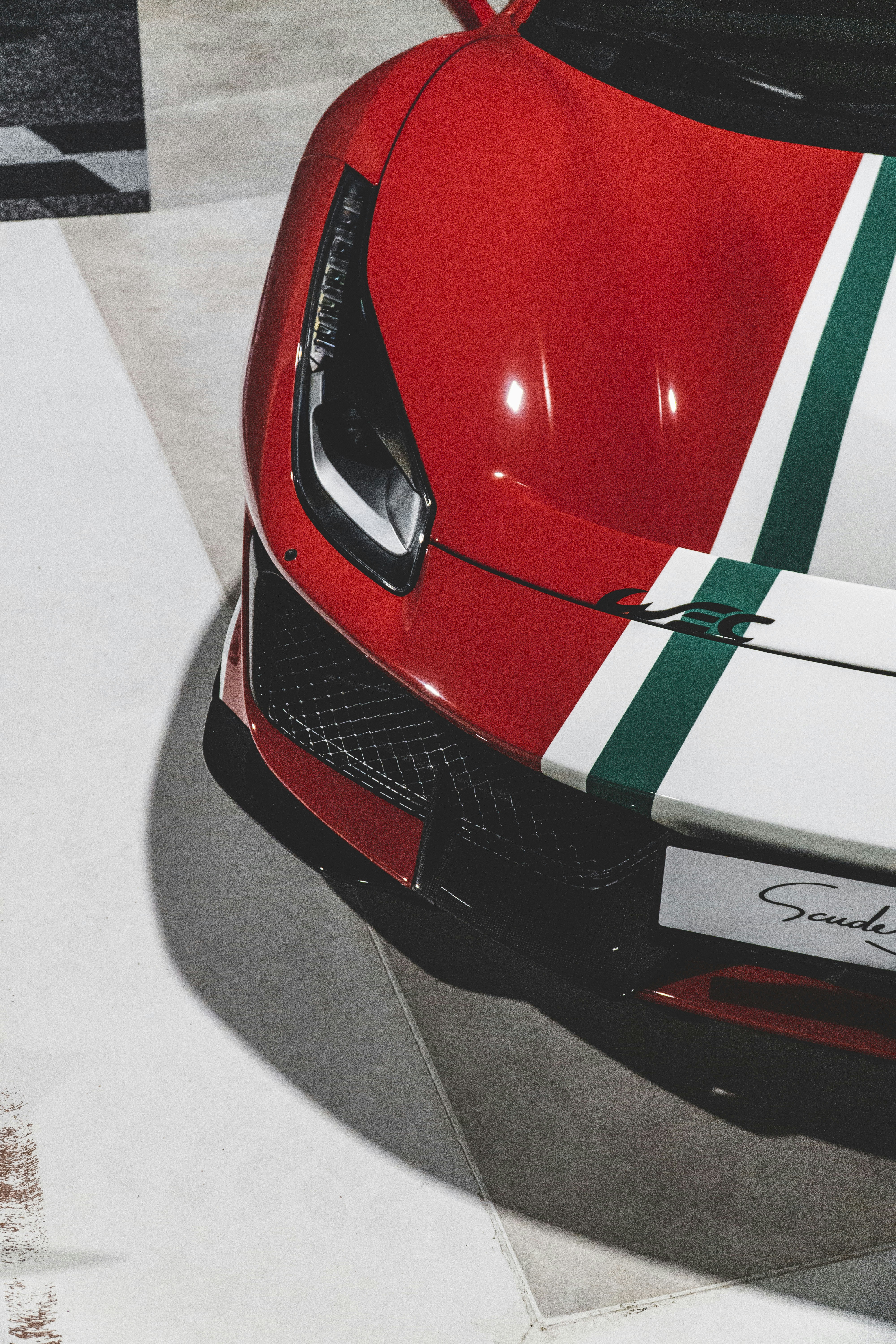 a red sports car with a green and white stripe