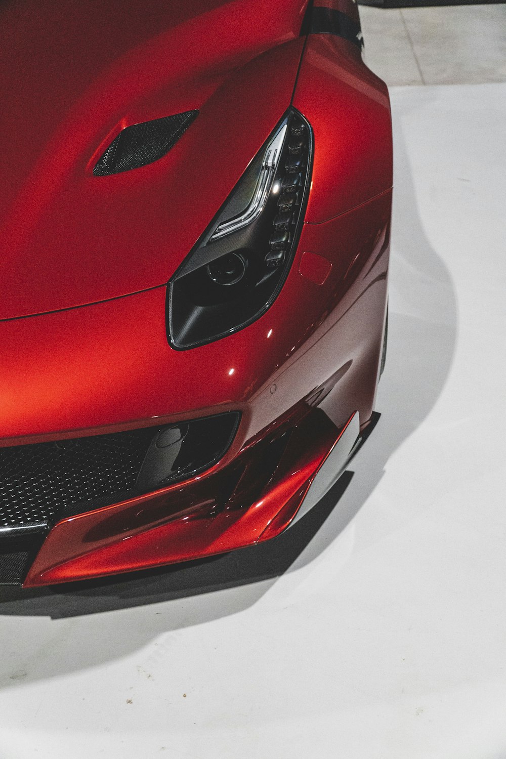 the front end of a red sports car