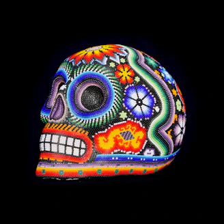 Vibrant large skull sculpture decorated with vivid Day of the Dead motifs and floral designs