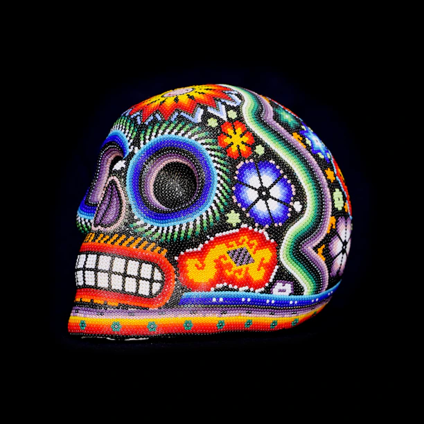 Vibrant large skull sculpture decorated with vivid Day of the Dead motifs and floral designs