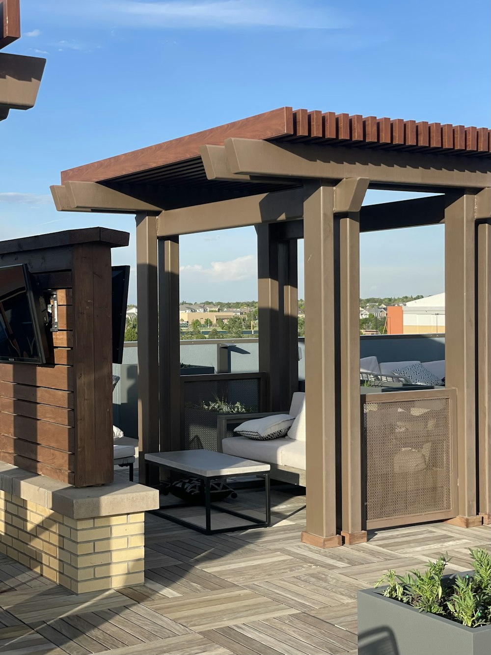 a covered patio with a couch and table