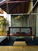 a wooden bench sitting under a wooden roof