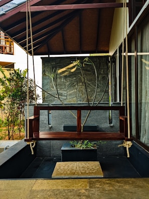 a wooden bench sitting under a wooden roof