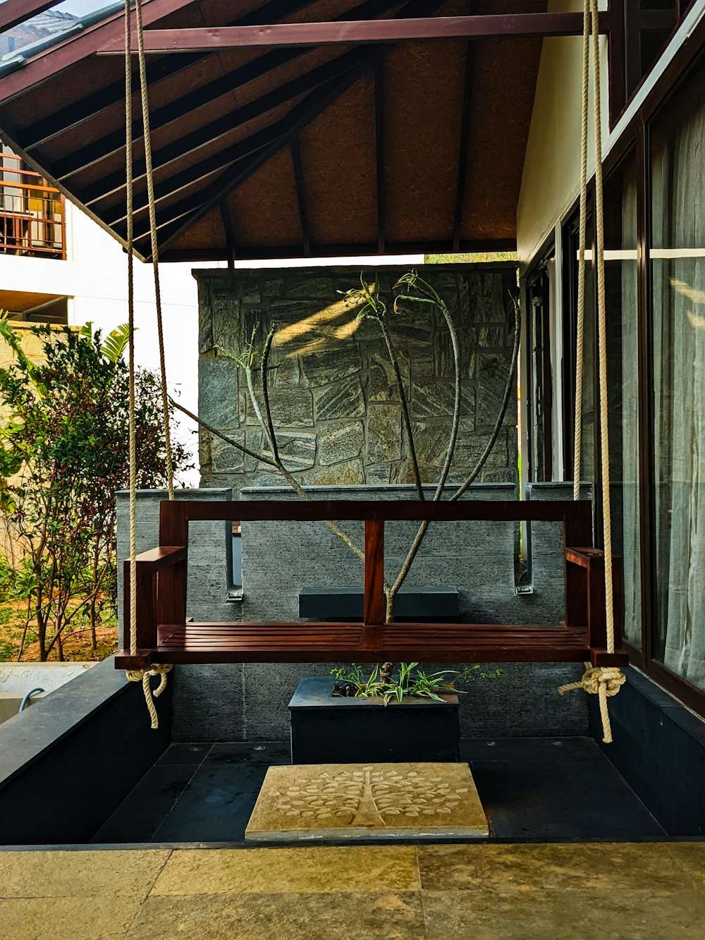 a wooden bench sitting under a wooden roof