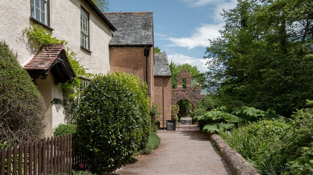 a pathway leading to a building with a gate