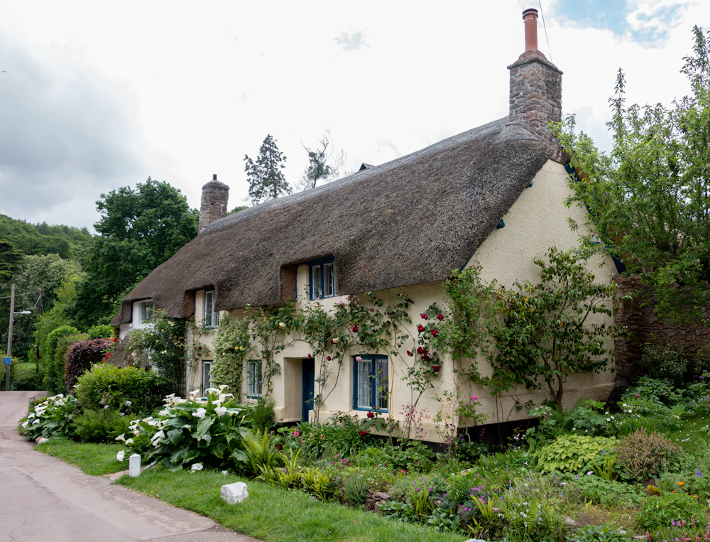 A thatched cottage surrounded by greenery
