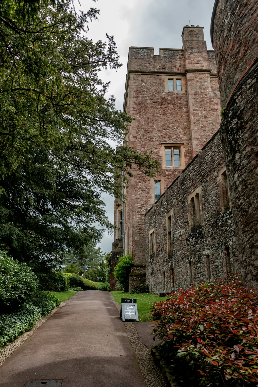 a large brick building with a walkway leading to it