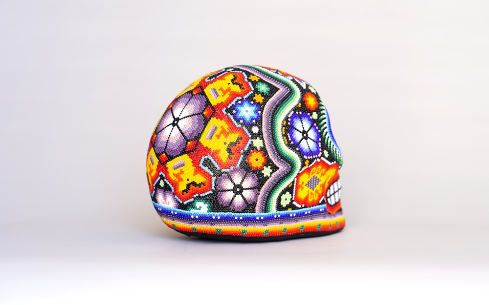 a colorful painted egg sitting on top of a table