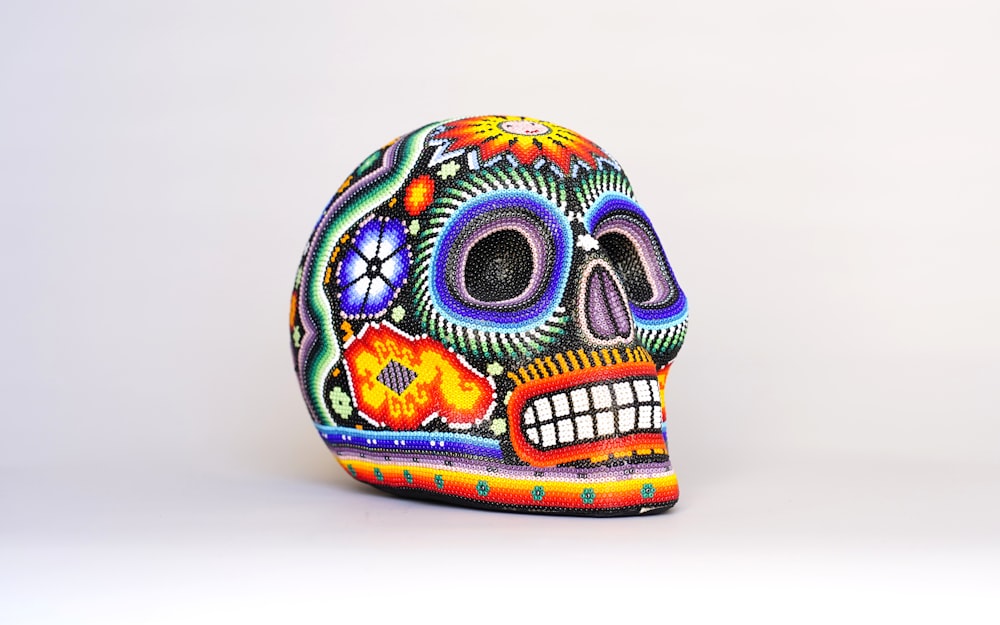 a colorfully painted skull on a white background