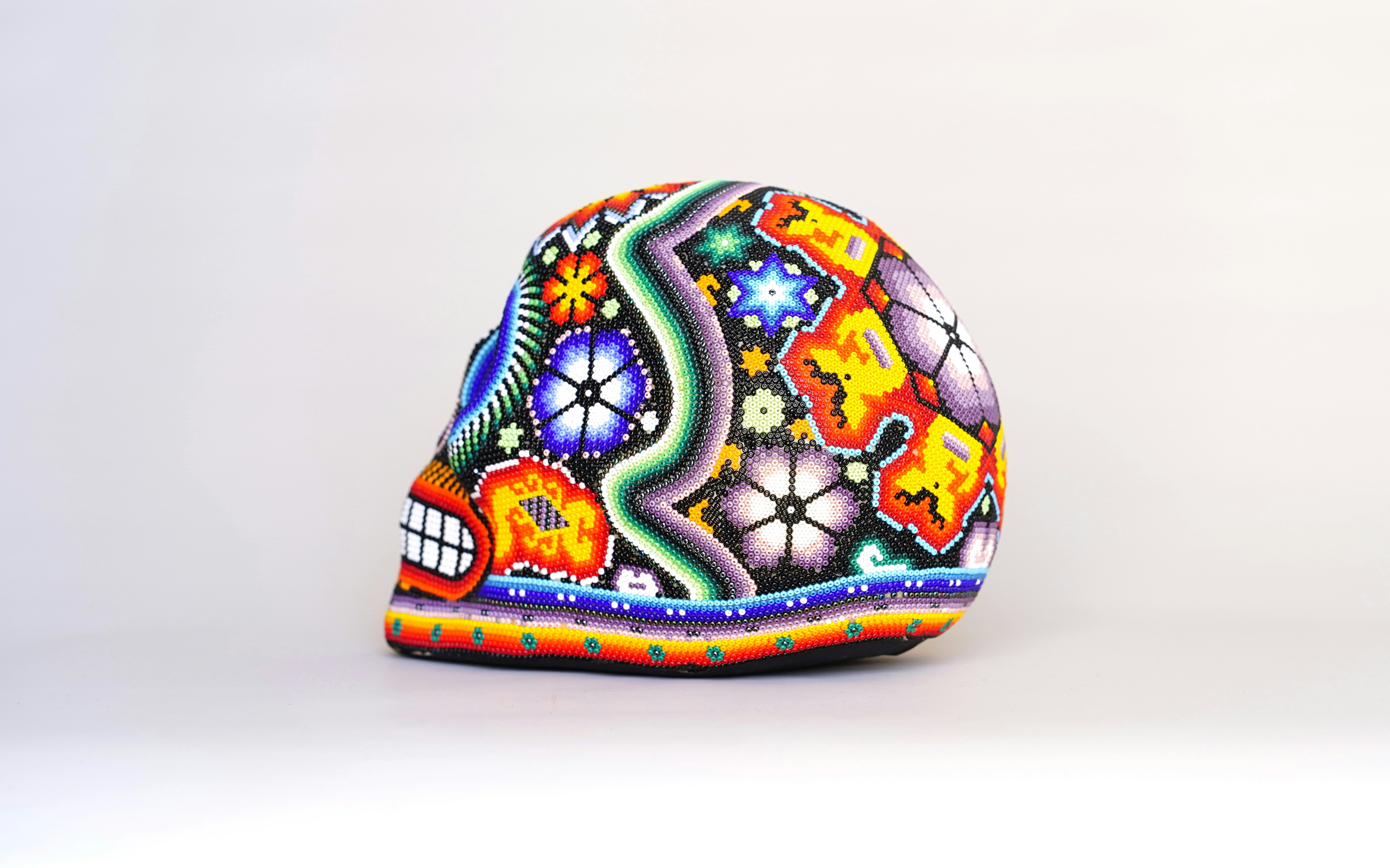a colorful hat is sitting on a white surface