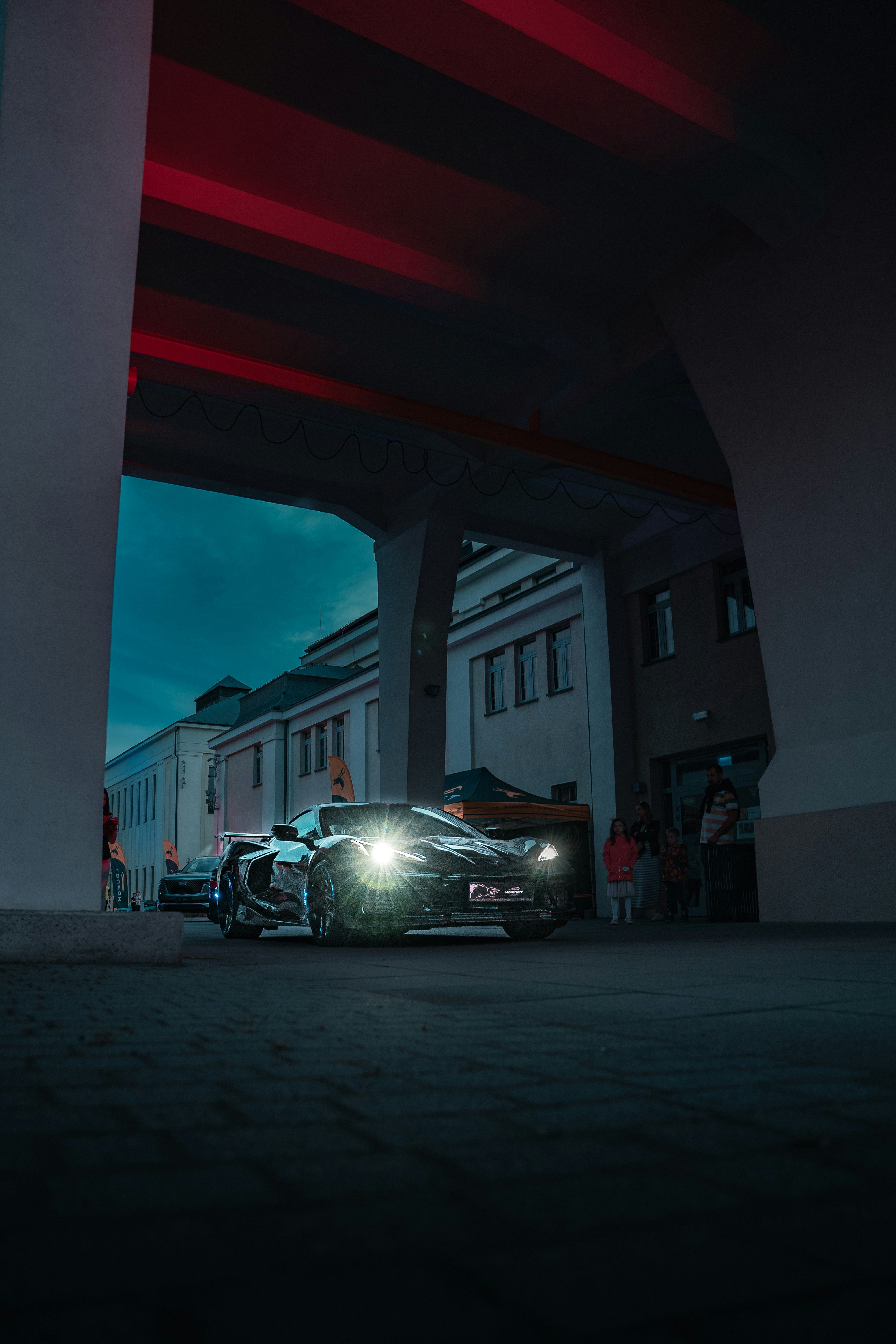 a car parked under a bridge at night