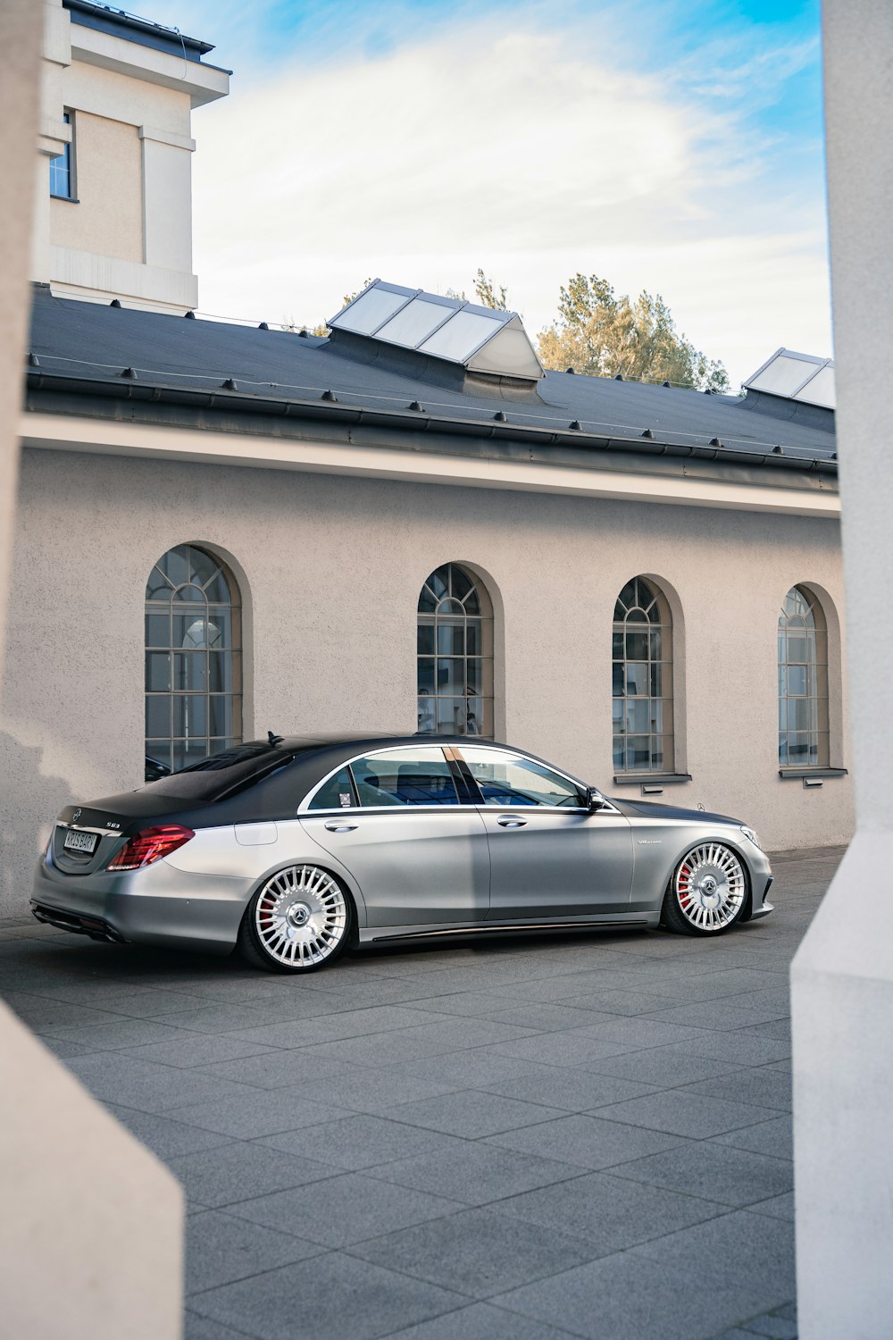 a silver car parked in front of a building