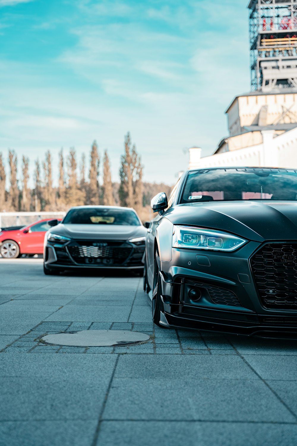 a couple of cars parked next to each other on a street