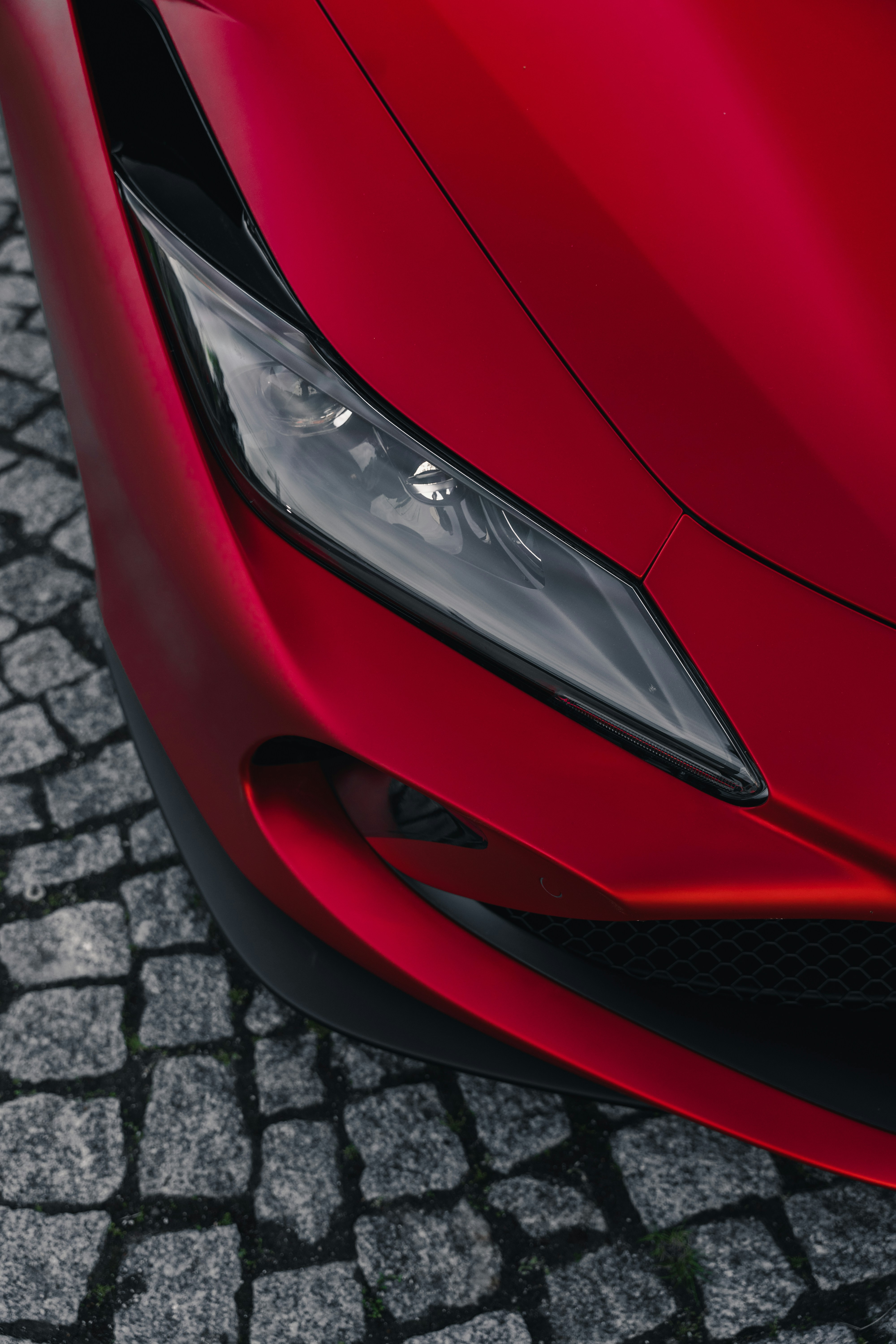 the front end of a red sports car