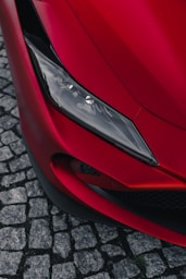 the front end of a red sports car