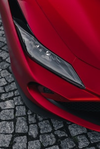 the front end of a red sports car