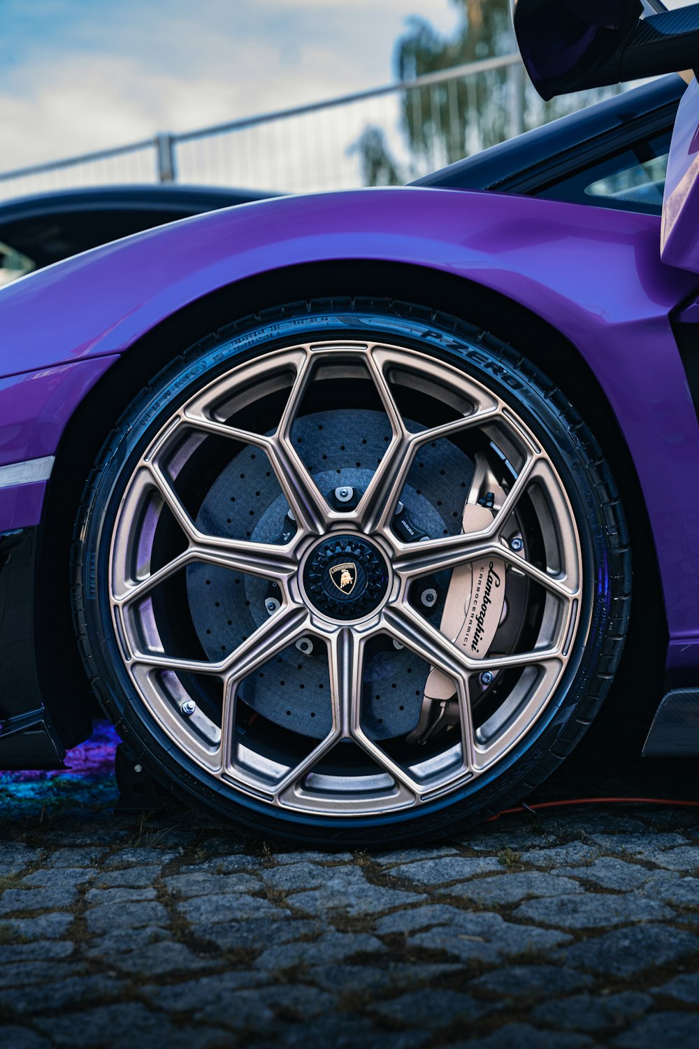 a purple sports car parked on the side of the road