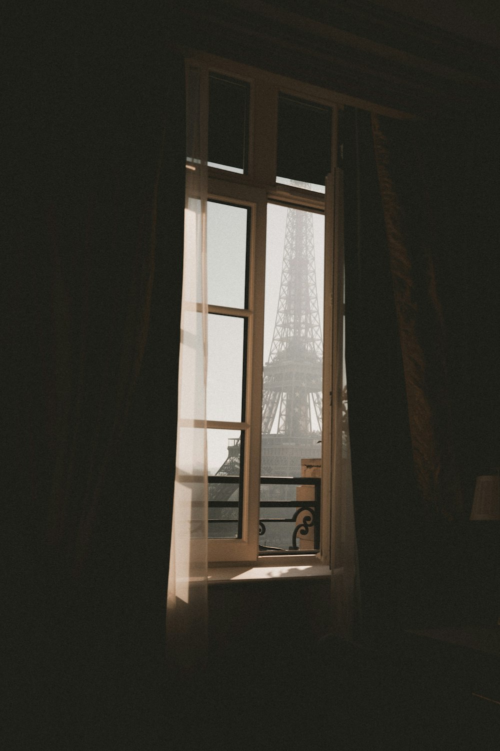 a view of the eiffel tower through a window