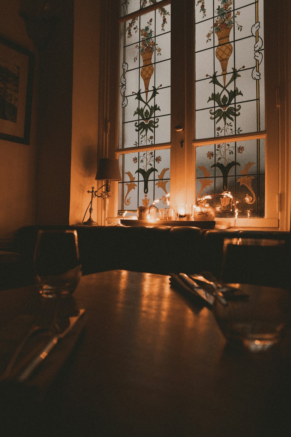 a table in front of a window with a lit candle