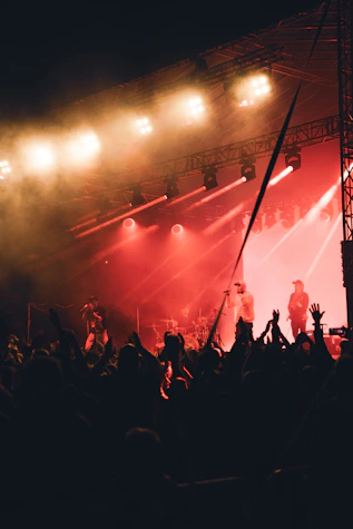A candid shot of Bridle Path performing under warm stage lights, guitars in hand, with an intimate crowd.