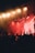 A close-up of a stage with dynamic lighting effects illuminating performers during a concert.