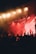 A close-up of a stage with dynamic lighting effects illuminating performers during a concert.