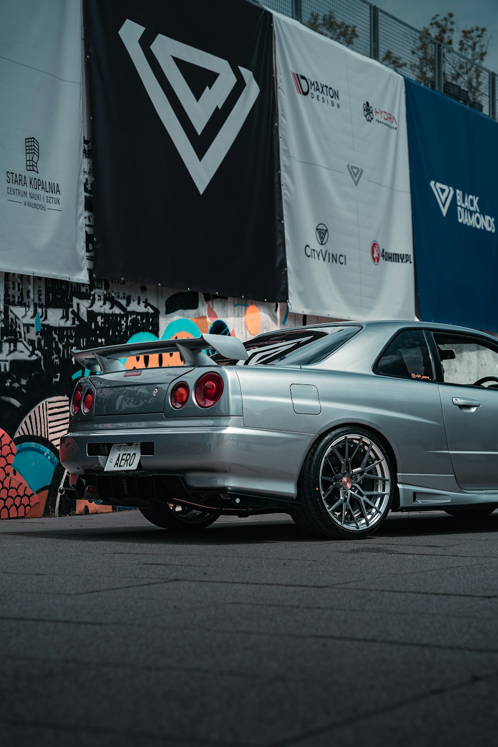 a silver car parked in front of a building