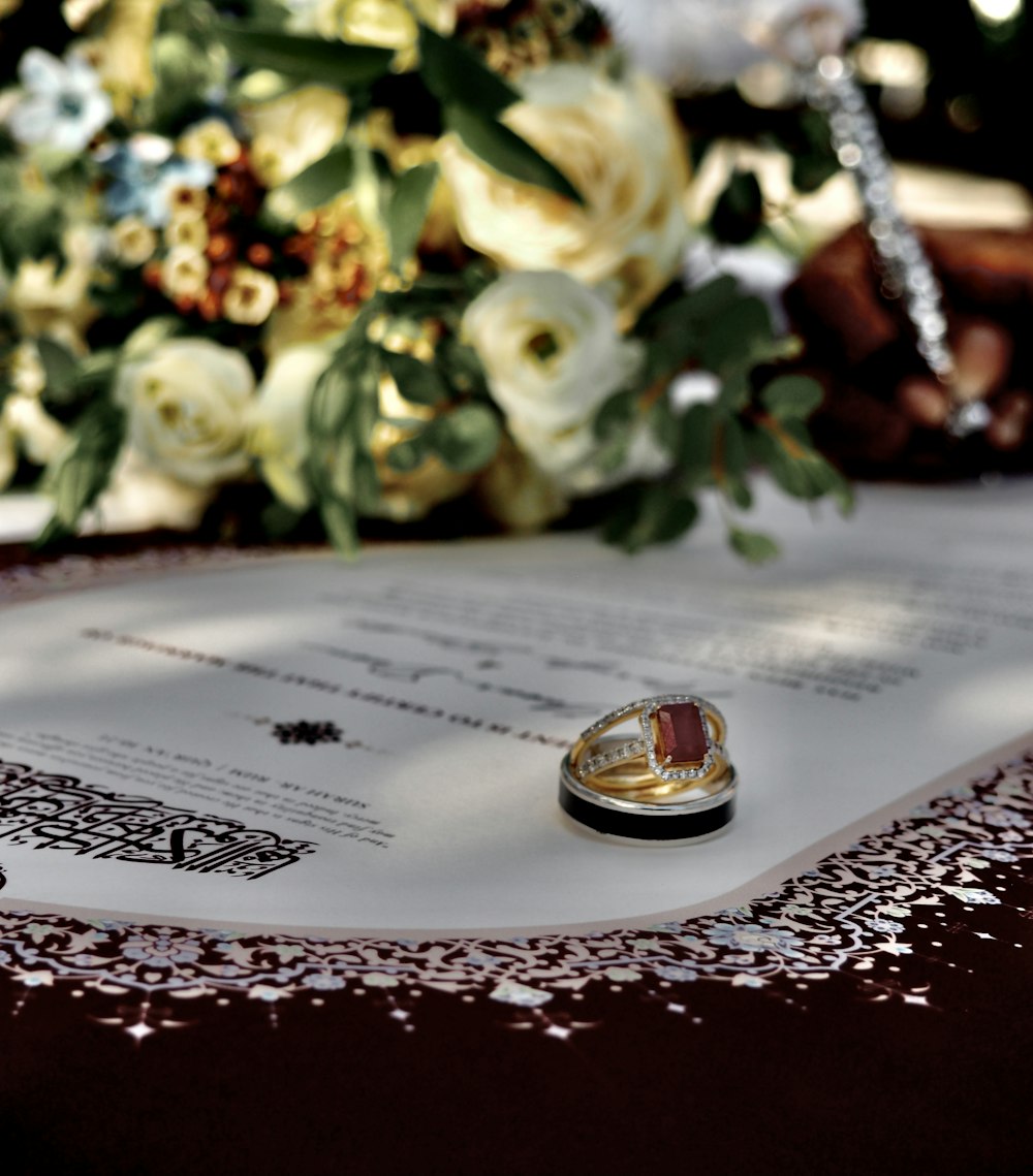 a wedding ring sitting on top of a piece of paper