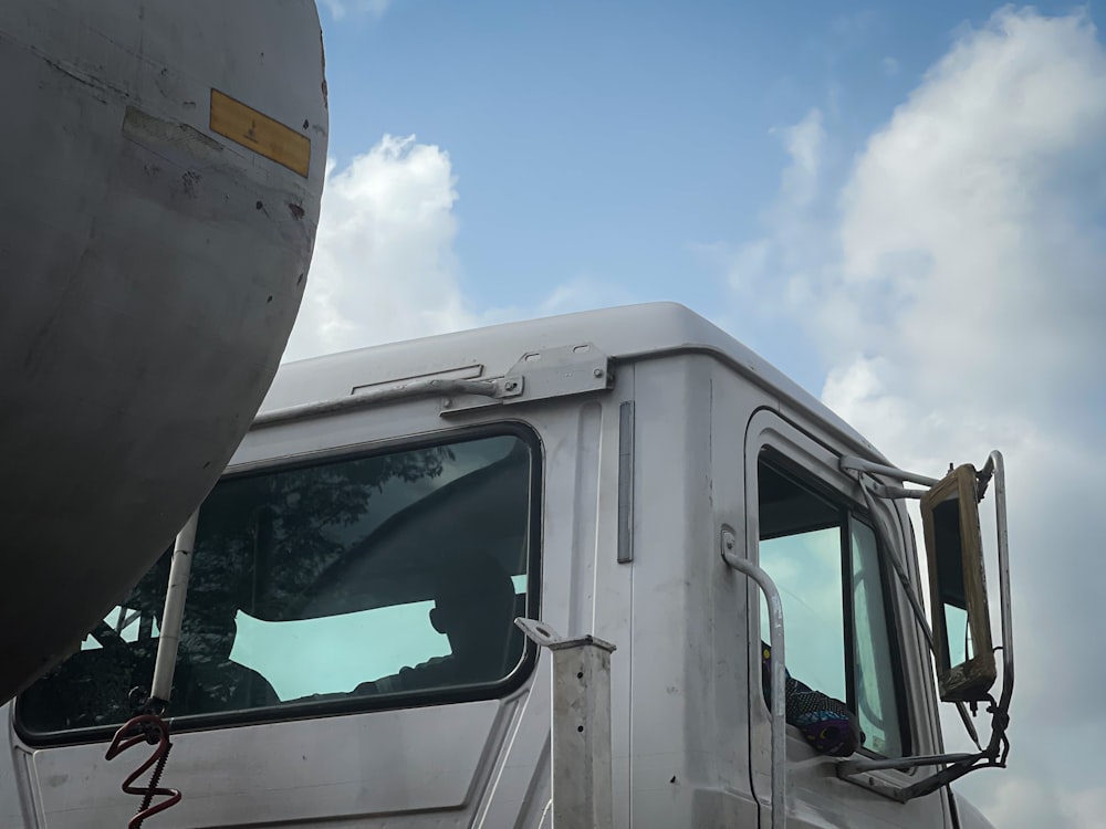 a white truck parked on a cloudy day