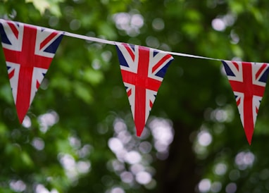 a british flag bunting on a tree line