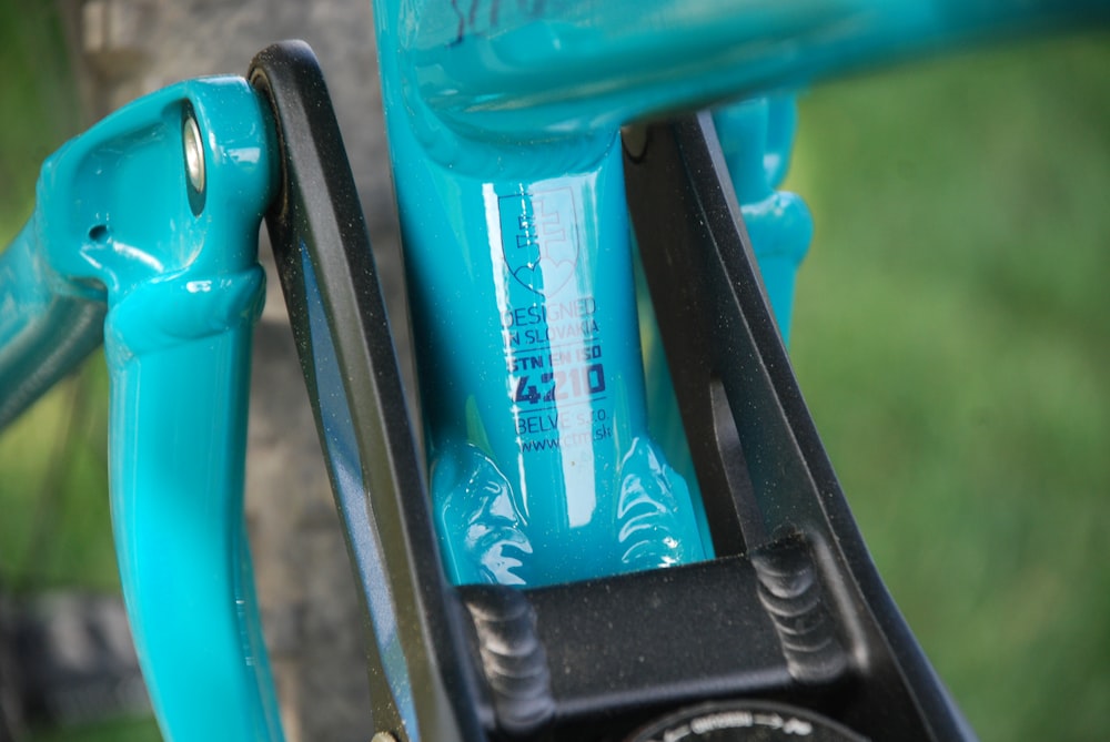 a close up of a blue bicycle handlebar