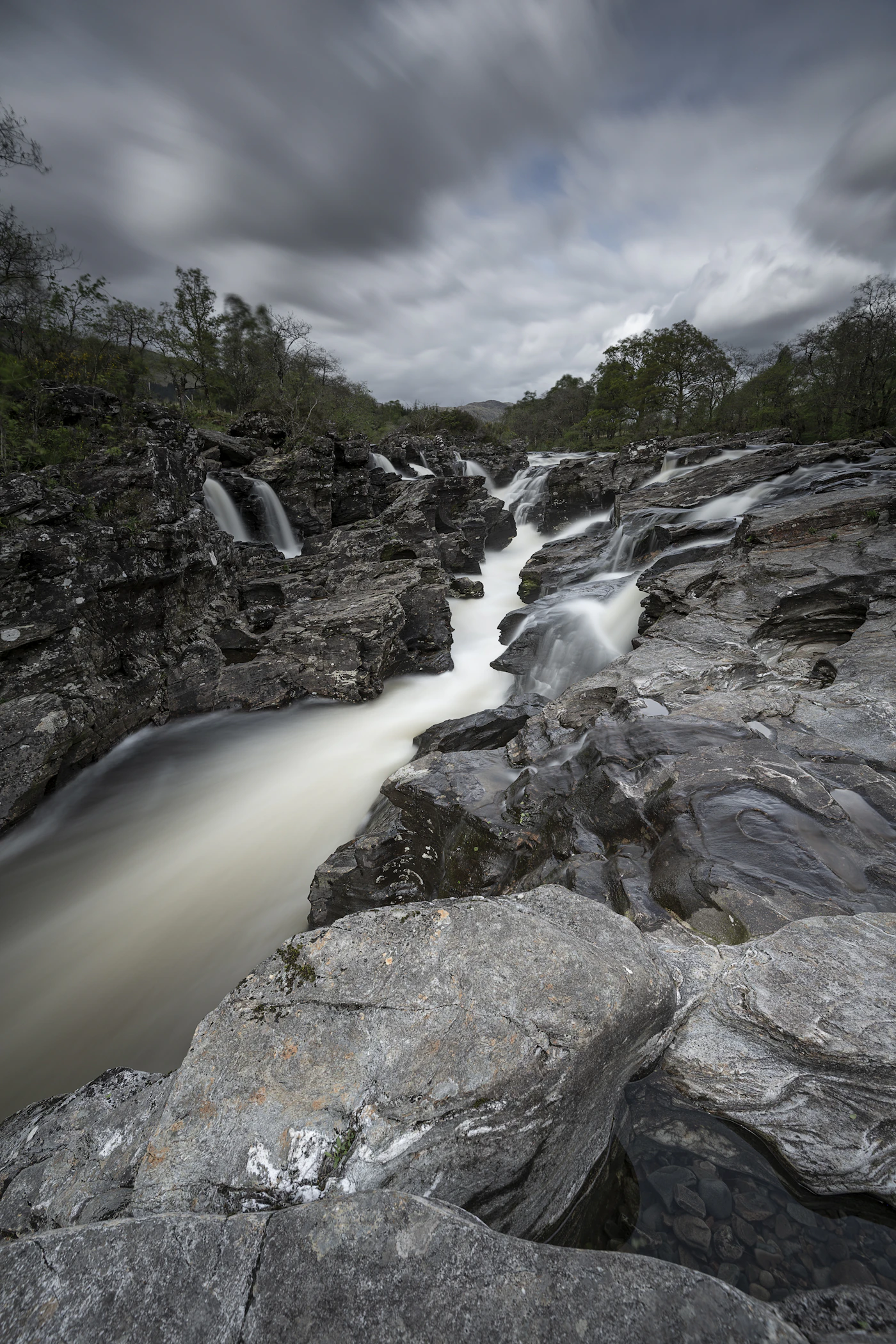 A river finding its way between rocks — not forcing, just flowing
