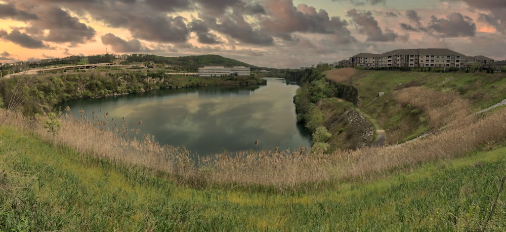 a large body of water surrounded by a lush green hillside