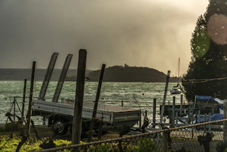 Close-up of hands shaking over a contract with a trailer in the background.