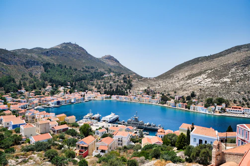 a harbor with a boat in it surrounded by mountains