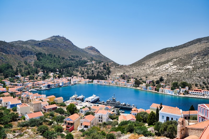 a harbor with a boat in it surrounded by mountains