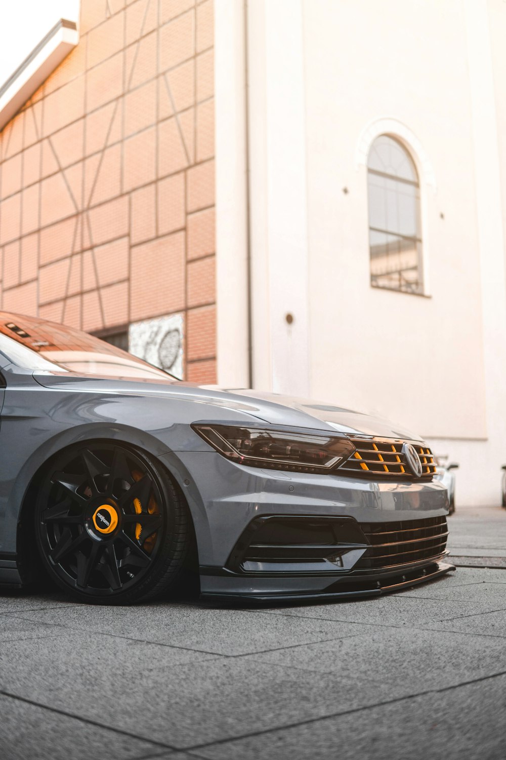 a grey car parked in front of a building