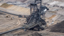 a large machine is in the middle of a quarry