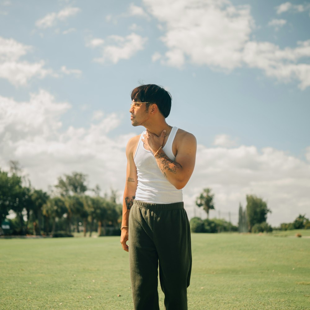 a man standing on a lush green field