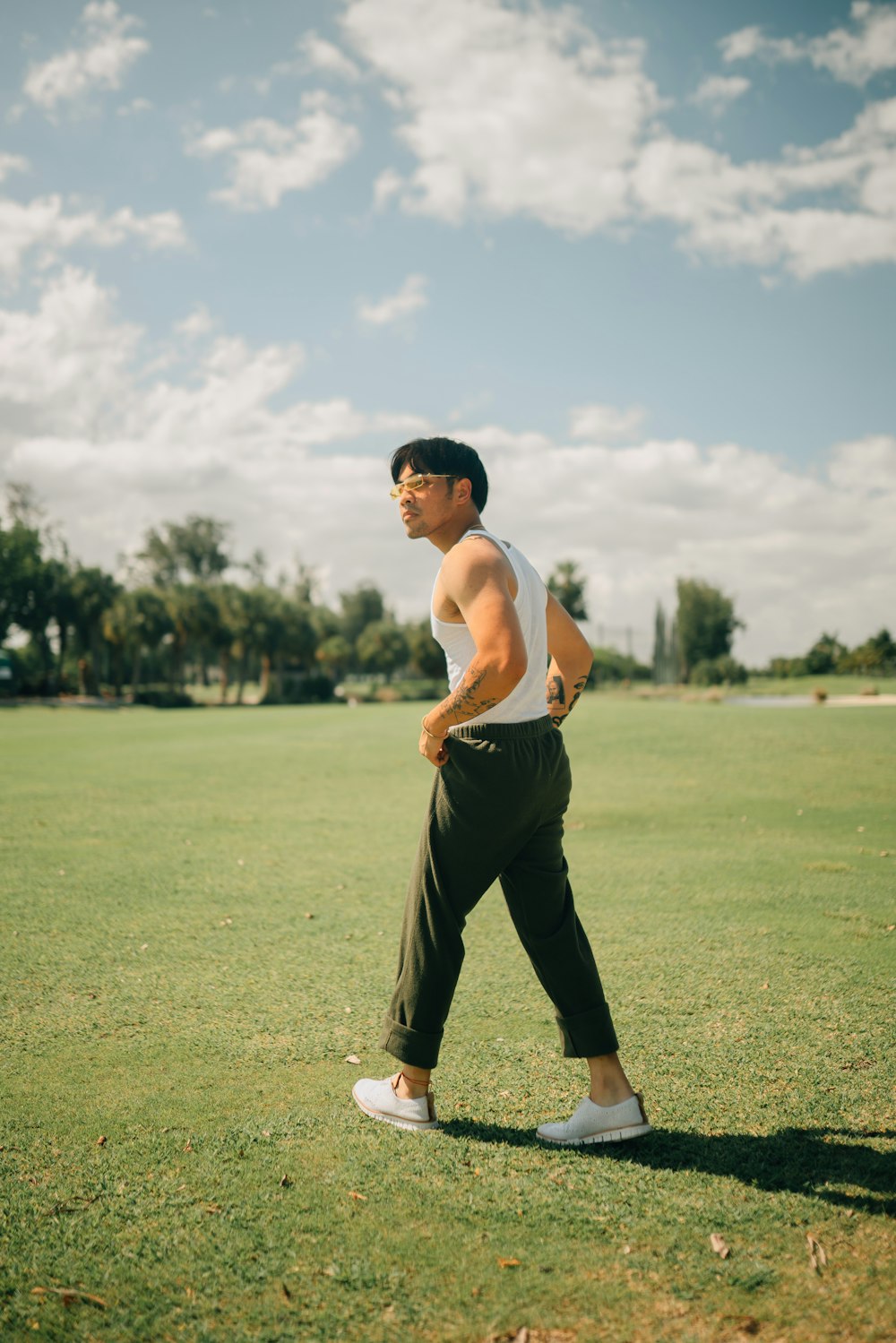 a man standing on top of a lush green field