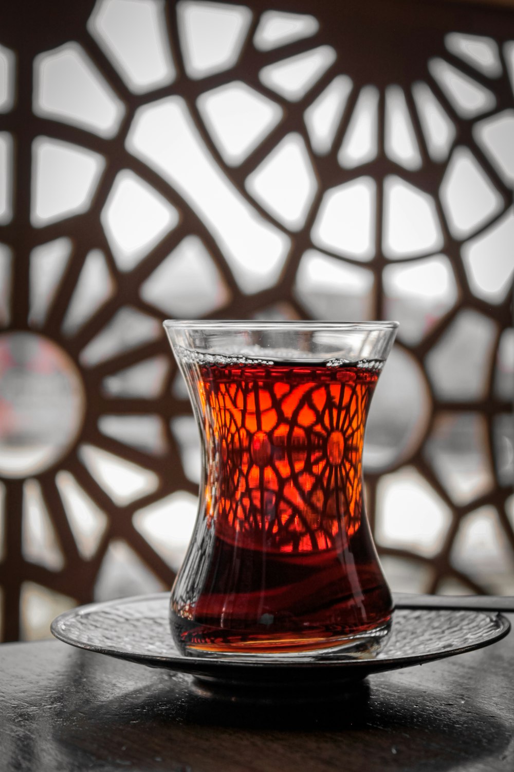 a glass cup filled with liquid sitting on top of a table