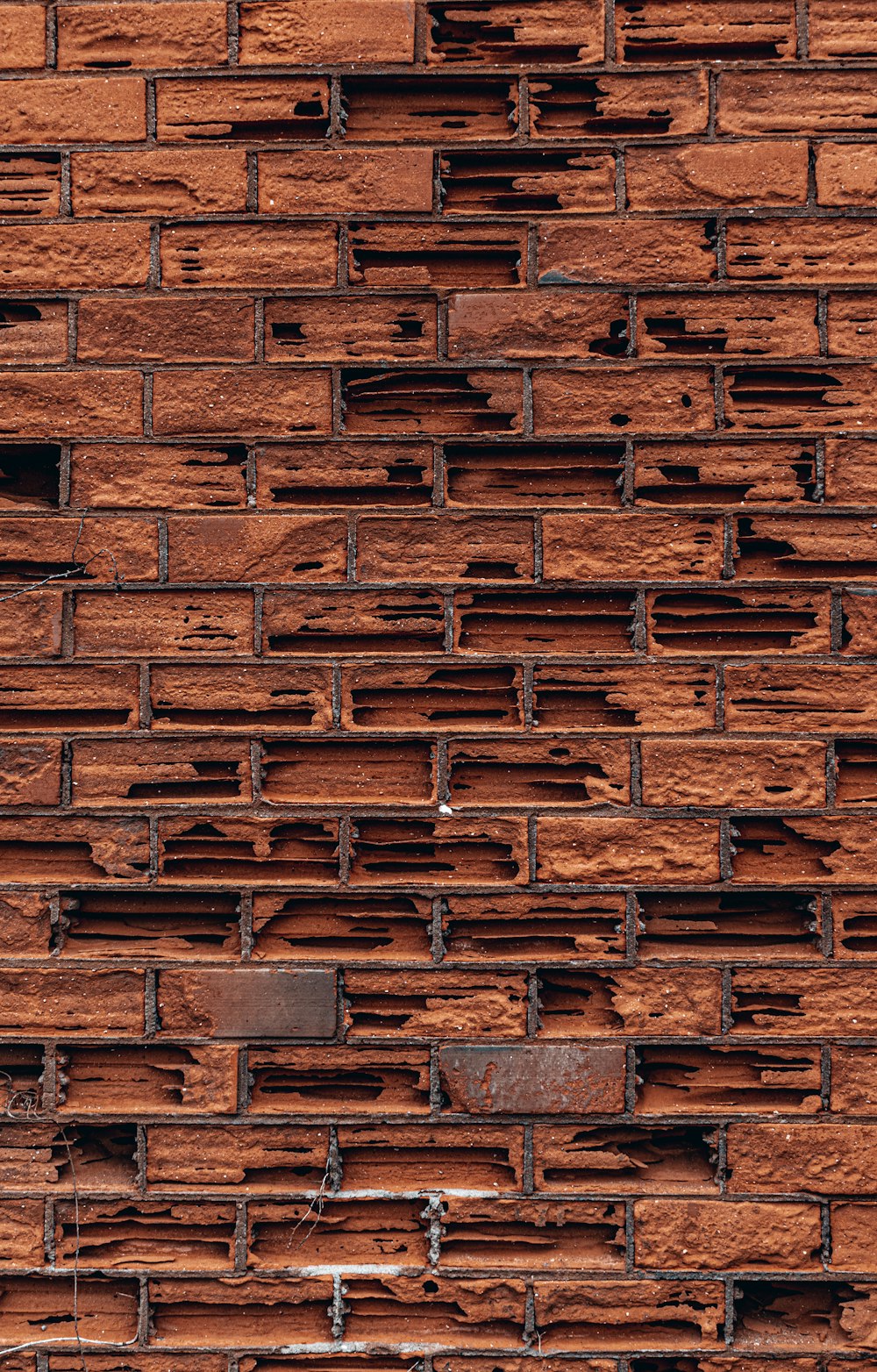 a close up of a brick wall with a clock on it