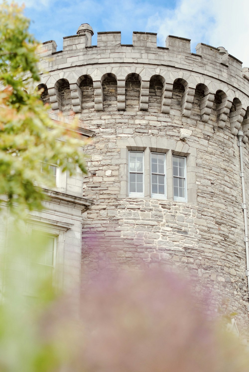 a tall brick tower with a clock on it's side