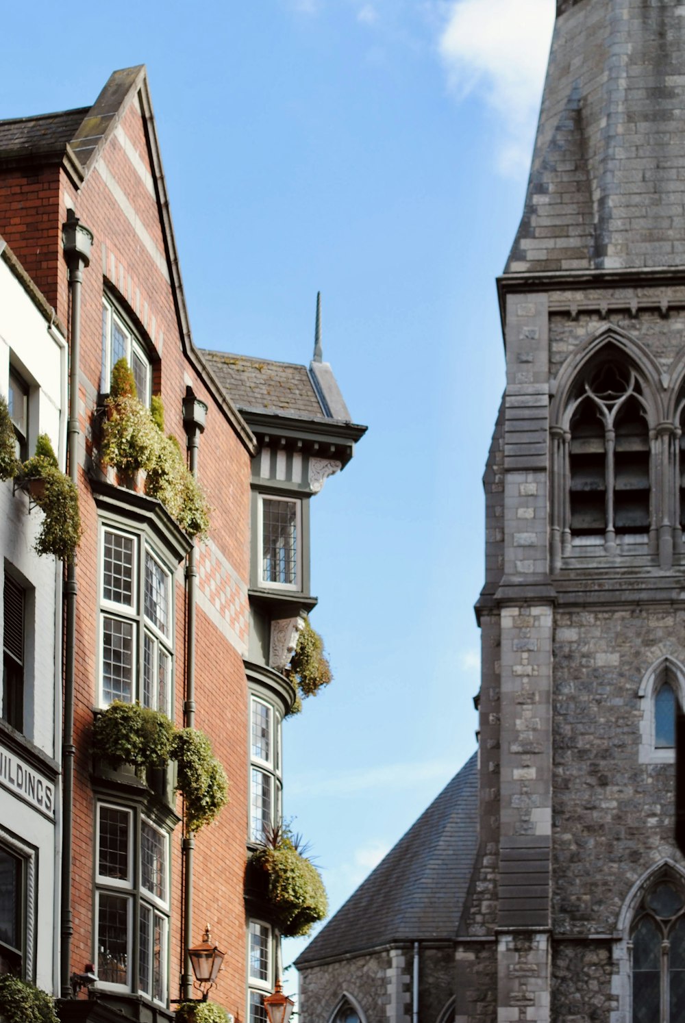 a tall brick building with a clock on it's side