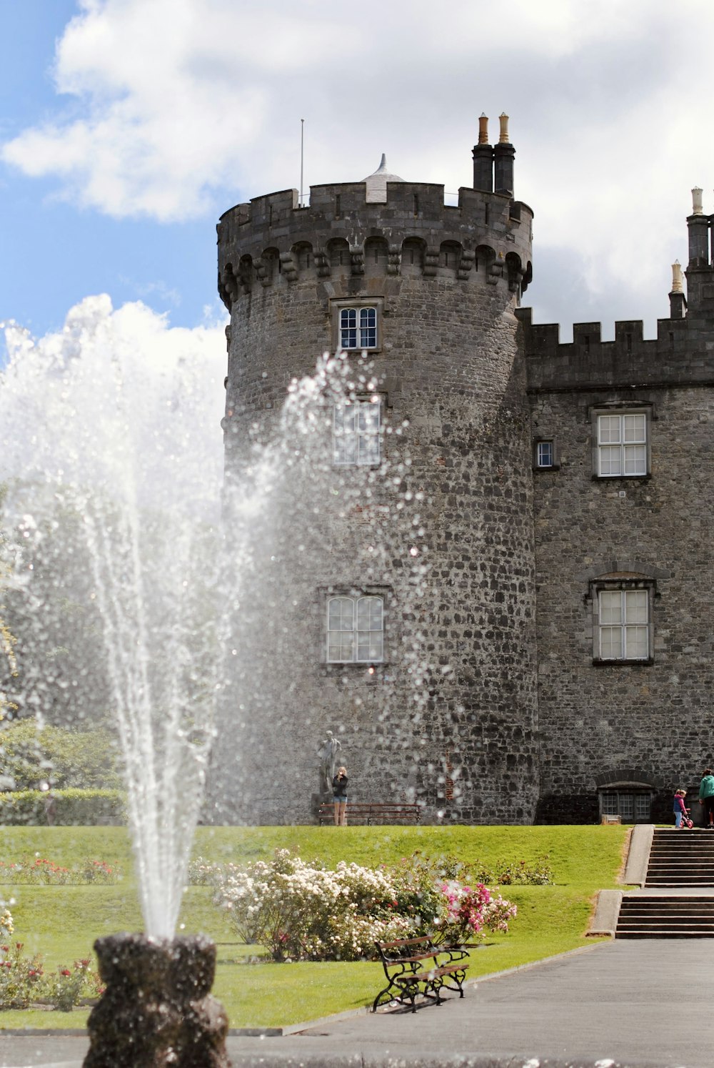 a large castle with a fountain in front of it