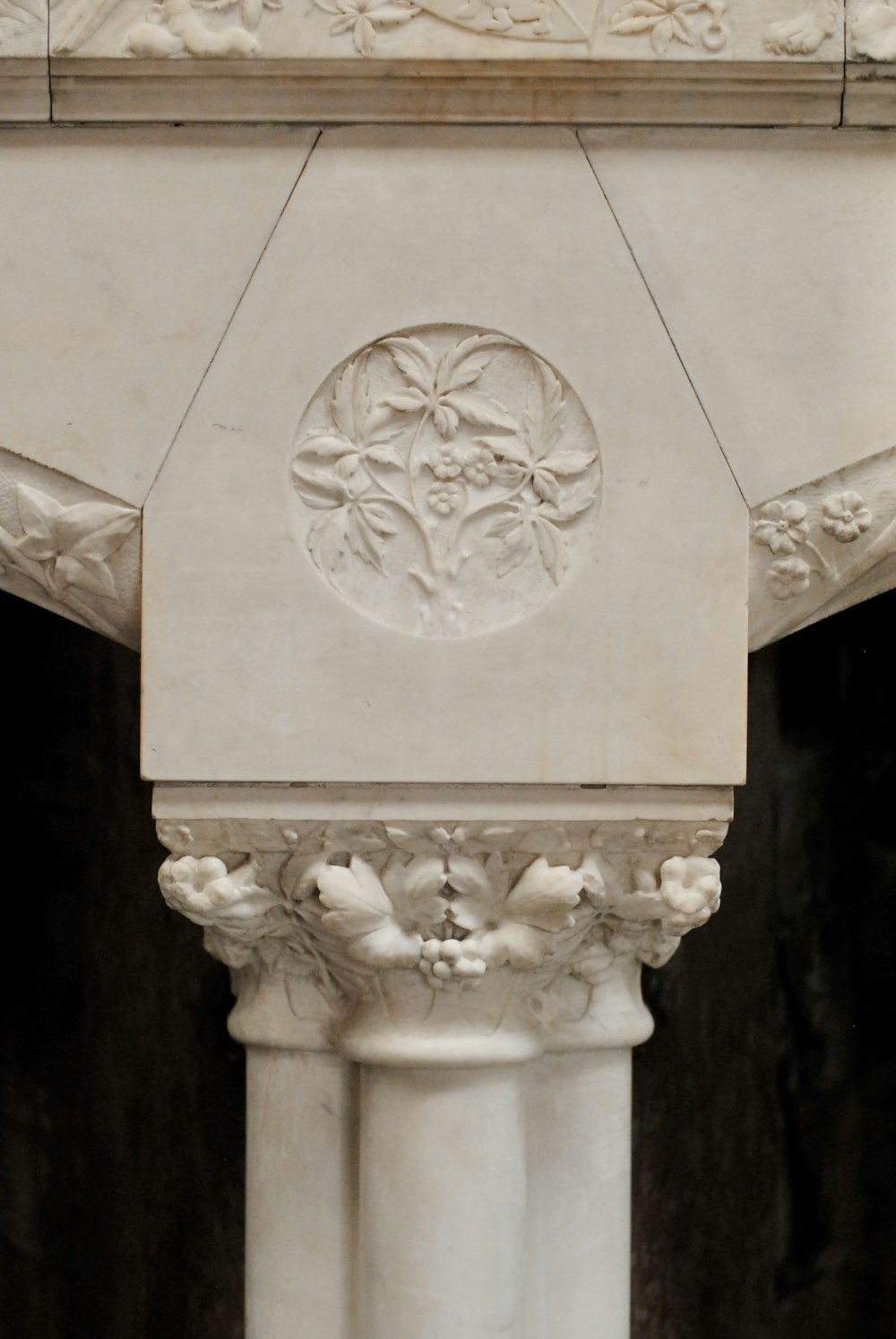 a close up of a pillar with a clock on top of it
